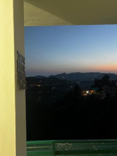 a view of a city from a window at Pine & Peaks in Patta