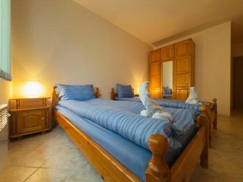 a bedroom with two beds with blue sheets at Panorama View-Stoykite in Stoykite