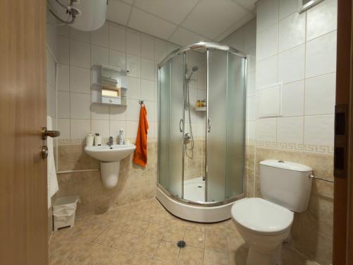 a bathroom with a shower and a toilet and a sink at Panorama View-Stoykite in Stoykite
