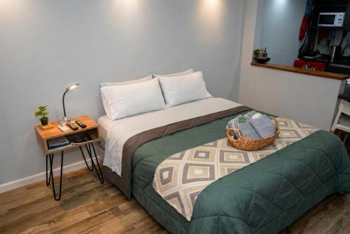 a small bedroom with a bed and a table at Estudio Lino in Córdoba