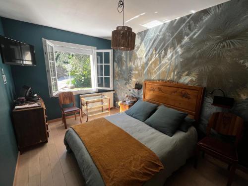 a bedroom with a bed with a painting on the wall at Chez Amélie in Crémieu