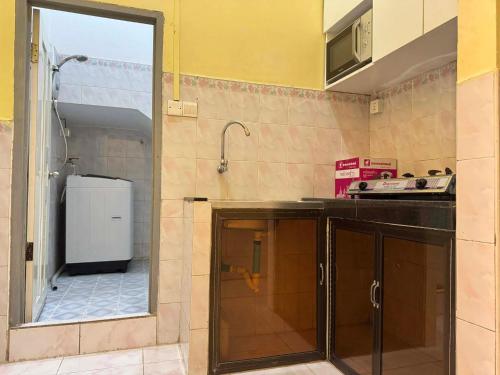 a kitchen with a sink and a refrigerator at Center Point Resident in Phnom Penh