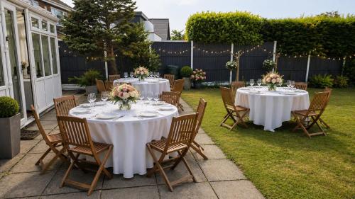 a set of tables with flowers on top of a yard at Royal Square Hotel - NEC & Birmingham Airport in Marston Green