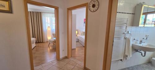a room with a bathroom with a sink and a mirror at Lake&Mountain Apartments in Andechs
