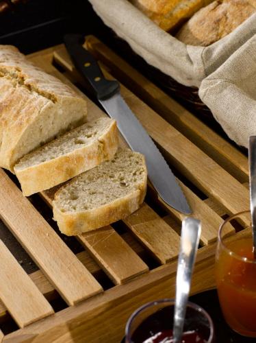 a tray with slices of bread on a cutting board with a knife at Campanile Cholet in Cholet