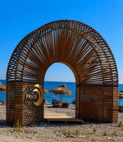 a building on a beach with the ocean in the background at PRIAM Beach Borsh in Borsh