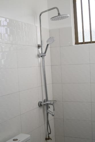 a shower stall in a bathroom with a toilet at Chama Haven Appartments in Tengeru
