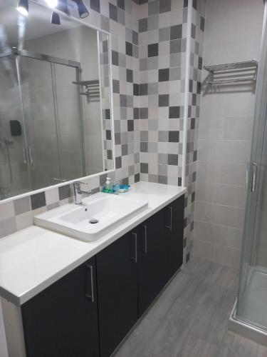 a bathroom with a sink and a shower at Casa de la Soledad 3 in Lugo