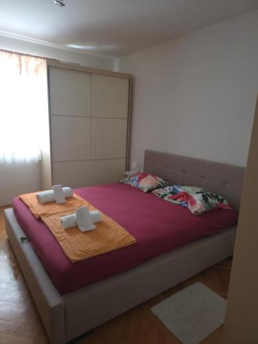 a bedroom with a bed with two crosses on it at Apartment Matea in Senj