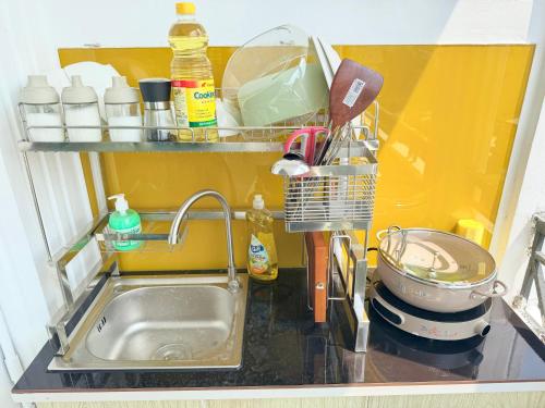 a kitchen counter with a sink and a sink at Hàng Xanh Stay in Ho Chi Minh City