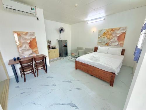 a bedroom with a bed and a desk in it at Hàng Xanh Stay in Ho Chi Minh City