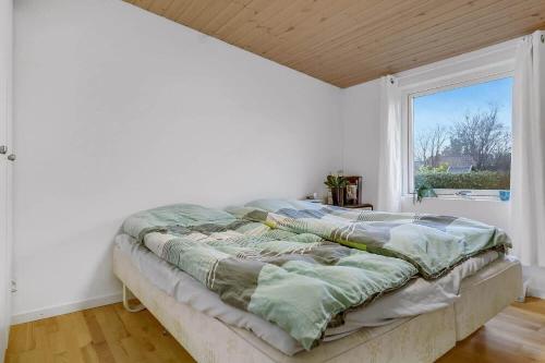 a large bed in a room with a window at 30140-Malling-Askvaenget-5 in Malling
