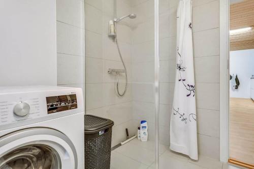 a bathroom with a washing machine and a shower at 30140-Malling-Askvaenget-5 in Malling
