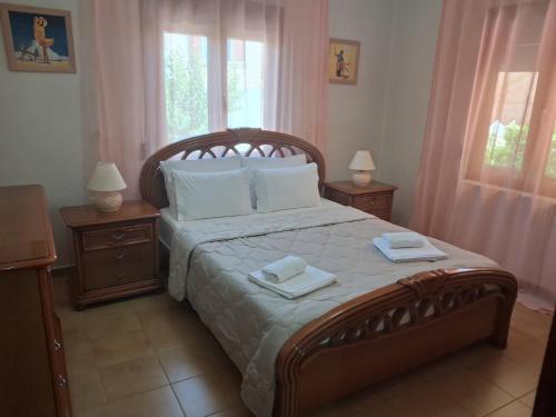 a bedroom with a large bed with two night stands at Sirena House in Limenaria