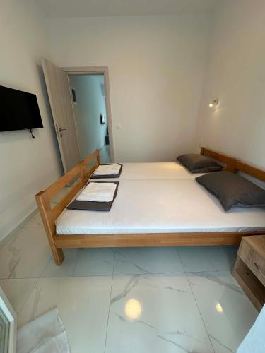 a bedroom with a large bed and a television at Sunset Apartment B-3 in Perea