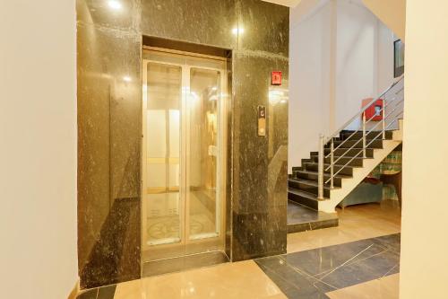 a hallway with a door and stairs in a building at Fabhotel Imperial 900 m from Sarnath Museum in Varanasi