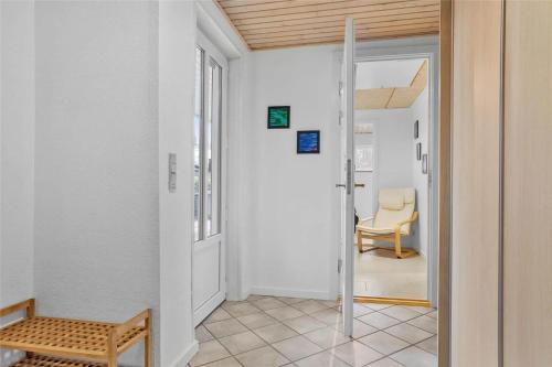 a hallway with a door to a room with a chair at 30640-Odder-Magevej-7 in Odder