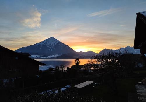 a view of a mountain at sunset with a lake at "Mon Rêve" Nature, Tranquility & Lake Thun in Sigriswil