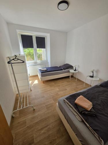 a bedroom with two beds and a window at Monteur-Apartment Kusel City in Kusel