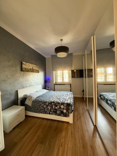 a bedroom with a large bed and aokedokedokedoked at 5 min from the center, Elevator , 4 guests, 2 bedrooms in Turin