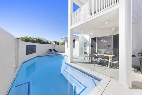 an image of a swimming pool in a house at Waves Beach House in Marcoola
