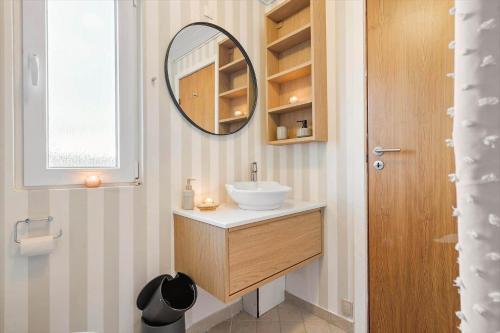 a bathroom with a sink and a mirror at 1115-Ringkobing-Nordsovej-466 in Søndervig