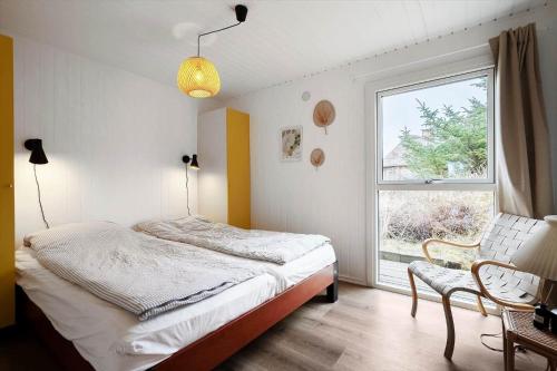 a bedroom with a bed and a window at 1115-Ringkobing-Nordsovej-466 in Søndervig
