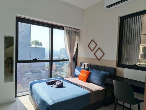 a bedroom with a bed and a large window at ICON CITY PETALING JAYA By WeCare in Petaling Jaya