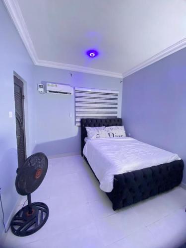 a bedroom with a bed and a chair in it at Legacy apartments in Ikeja