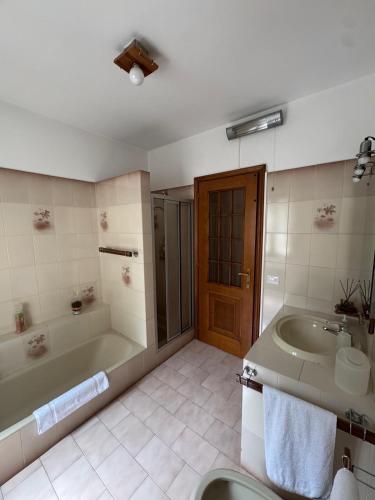 a bathroom with a tub and a sink at La casa di Ernesto in Carlazzo