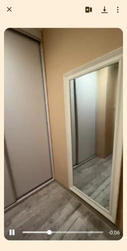 a bathroom with two sliding doors and a mirror at Kawalerka in Kwidzyn