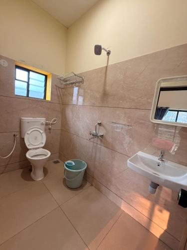 a bathroom with a toilet and a sink at Golden rays beach stay in Mangalore