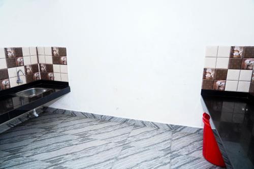a bathroom with a tile floor and a sink at River side in Vagamon