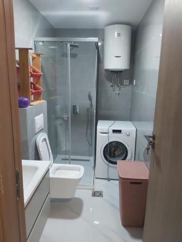 a bathroom with a shower and a toilet and a sink at Apartment Miki in Bar