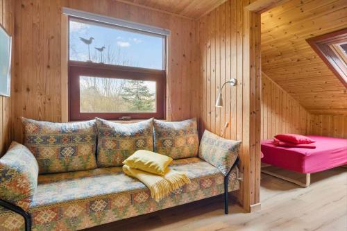 a couch sitting in a room with a window at 30168-Odder-Pouli-Nielsensvej-3 in Odder