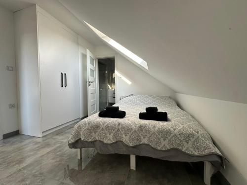 a bedroom with a bed with two towels on it at Podlaska Oaza in Przejma Wielka