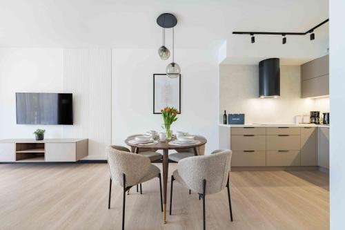 a kitchen and dining room with a table and chairs at Apartament Panorama Pod Dębowcem in Bielsko-Biała