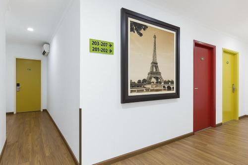 a hallway with doors and a picture of the eiffel tower at Hotel Sunjoy9 Bandar Sunway in Petaling Jaya