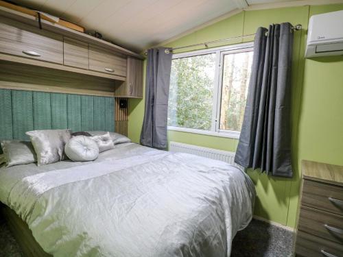 a bedroom with a large bed and a window at Wild Duck Holiday Park in Belton