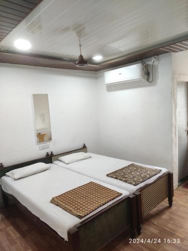 a bedroom with two beds in a room at Hotel heena in Bīr
