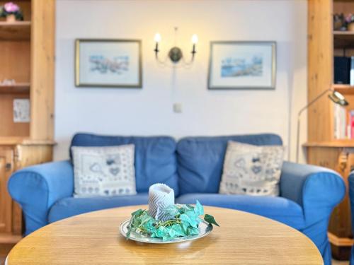 a living room with a blue couch and a table at Sonnenhof Seeg 01 in Seeg