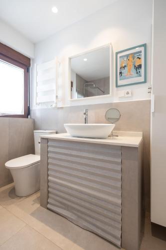 a bathroom with a sink and a toilet at Villa Clio by Concept Flats in Novaliches