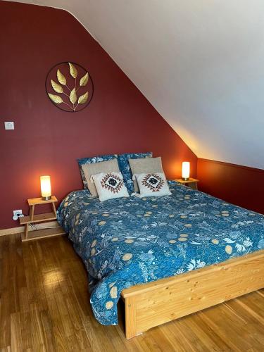a bedroom with a bed with two lamps on two tables at Maison avec sauna en Presqu'île de Crozon pour 6 personnes in Crozon