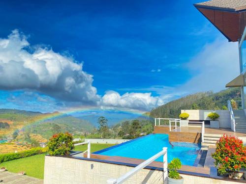 a house with a swimming pool with a view at Hilldale Retreat in Nuwara Eliya