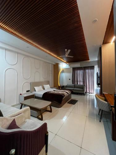 a hotel room with a bed and a couch at Nagarkoti Residency Inn in Pithorāgarh