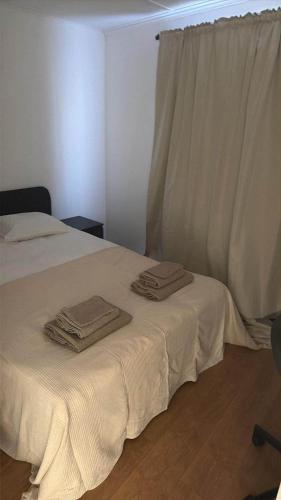 a bedroom with a bed with towels on it at Petit chambre tous conforts in Charleroi