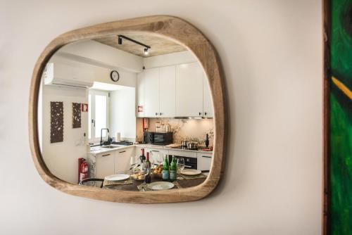a kitchen with a mirror on a wall at Casas dos Machados in Tavira