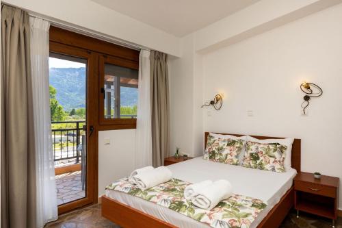 a bedroom with a bed and a window with a view at Porto Marina in Chrysi Ammoudia