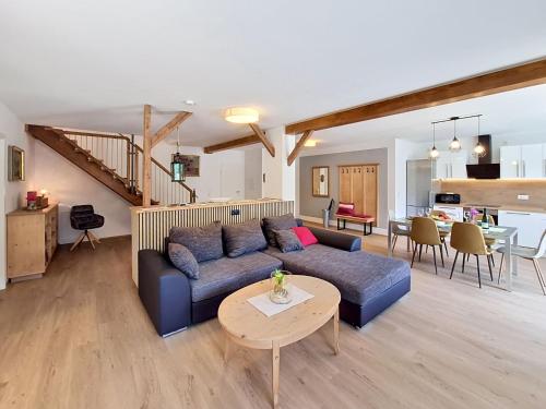 a living room with a blue couch and a table at Apartment Halbeis by Interhome in Matrei am Brenner