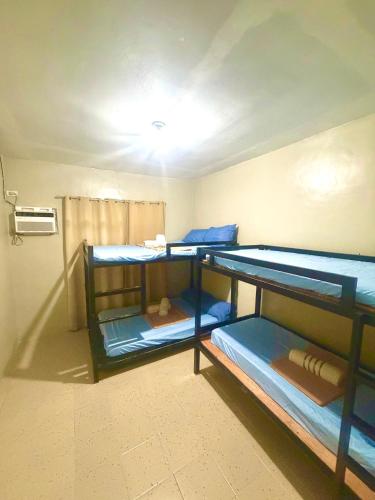 a room with three bunk beds in it at Maru Vibe Guesthouse V2 in San Juan